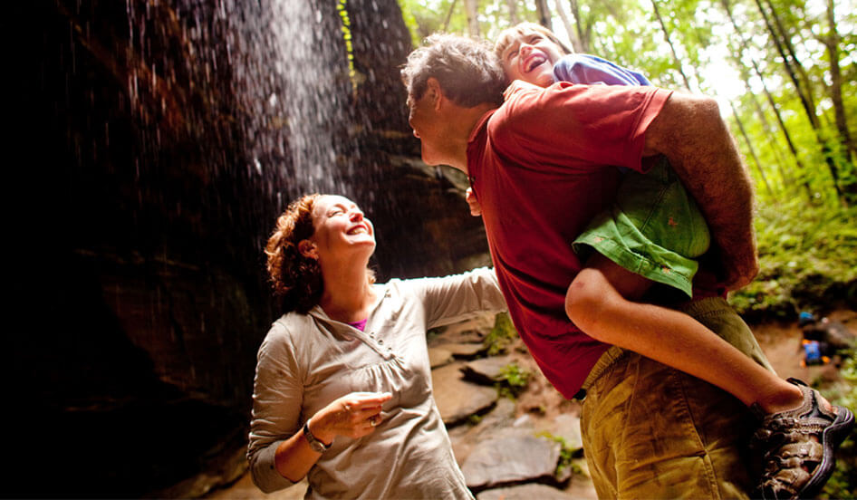 Family enjoying Moore Cove Falls in Pisgah National Forest, near Brevard, NC.