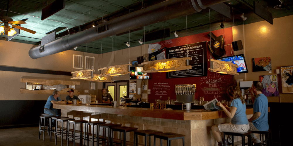 People sitting at the bar at Brevard Brewing in Downtown Brevard.