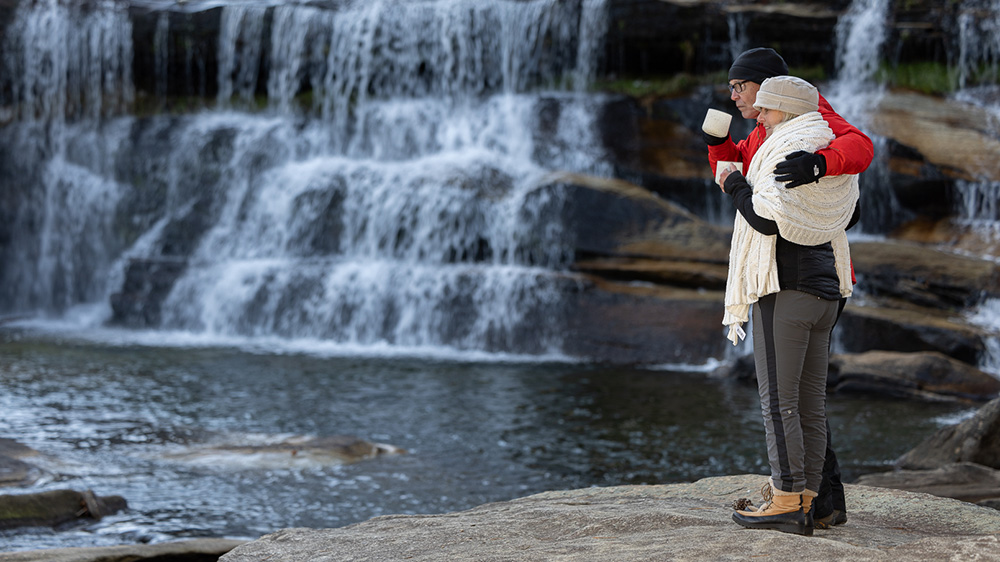 Couple at a Waterfall Go on a Guided Adventure Warm Up with a Winter Coffee Hike-explore-brevard