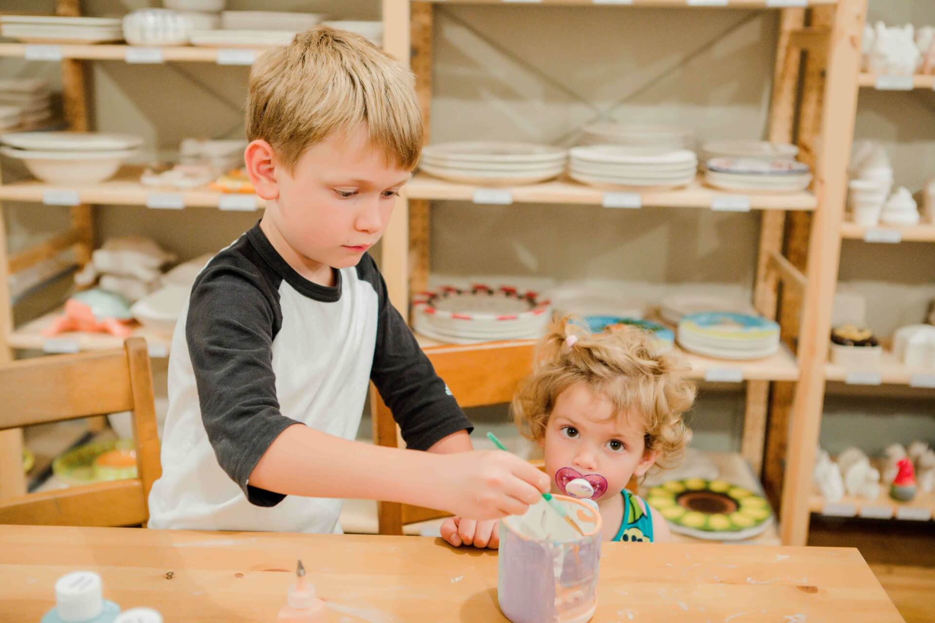 Kids painting pottery at Brevard Clay in Downtown Brevard